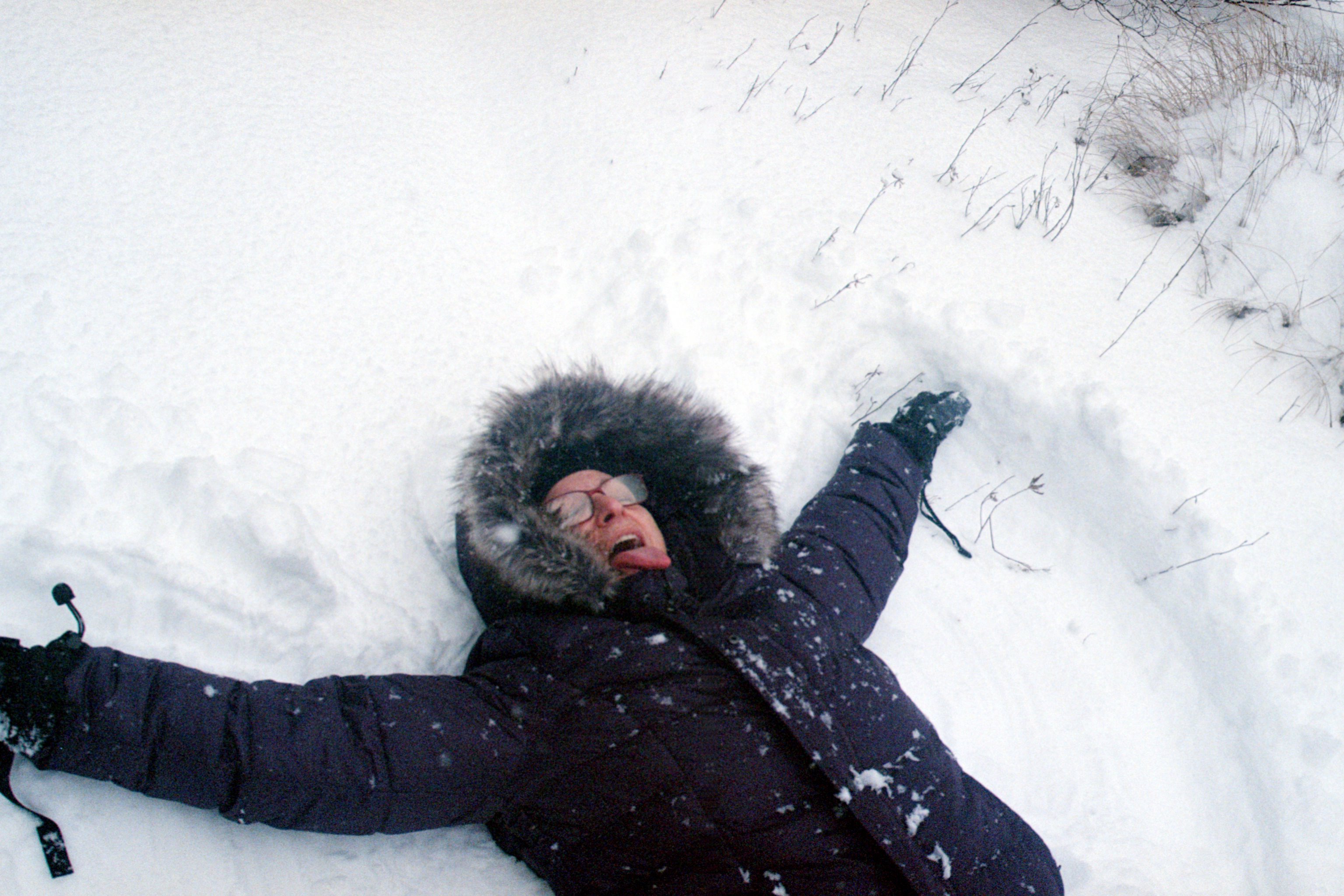 Julie making a snow angel during treatment, from the ADY blog post Don't call me a survivor